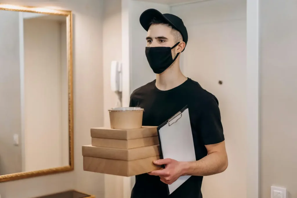Man in Black T-shirt Delivering Food in Boxes